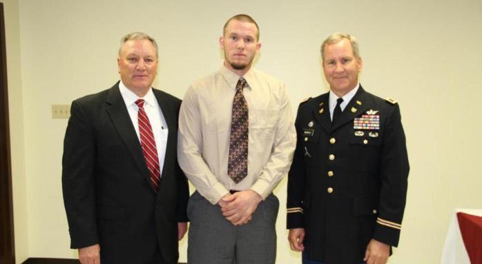Dennis Robertson, center, is pictured with Holmes Head Football Coach Jeff Koonz and Colonel Bradly MacNealy. The football coaching staff created the Bradly MacNealy Leadership Award in MacNealy's honor and presented the award the award to Robertson at the football banquet on Wednesday night in Goodman.